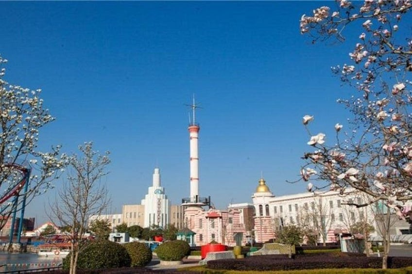 A tower, a building with a golden dome, and blooming trees. 2