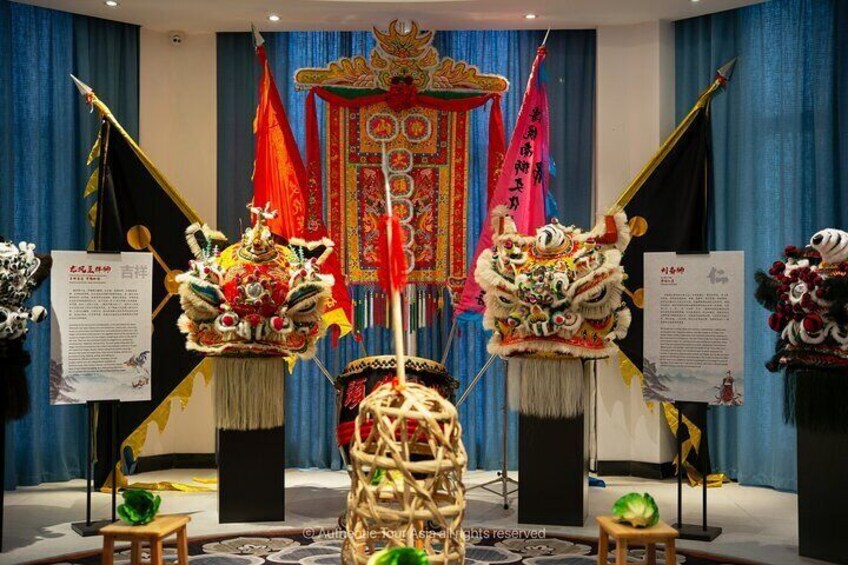A display of traditional Chinese lion dance costumes in a museum. 4