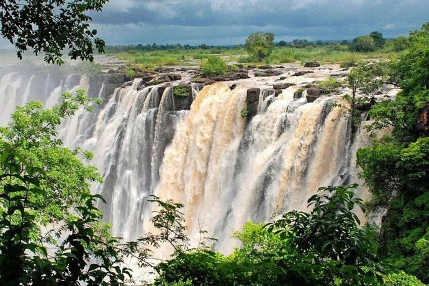 A large waterfall with multiple cascades surrounded by lush greenery. 4