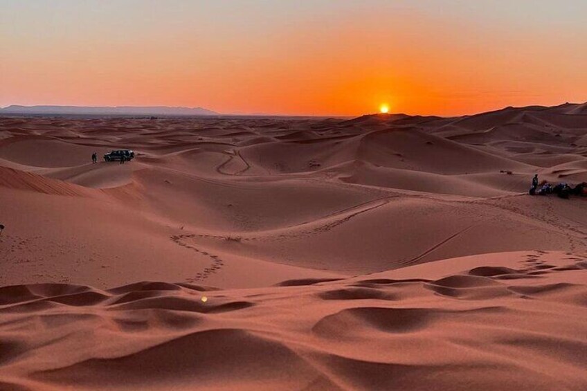 A desert landscape with sand dunes and a sunset. 3