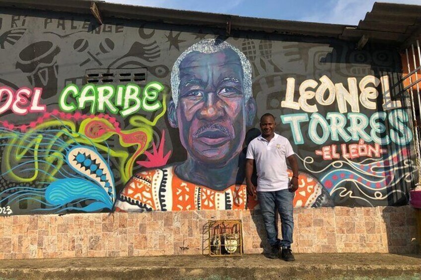 A mural with vibrant colors and text including 'DEL CARIBE' and 'LEONE TORRES'. 2