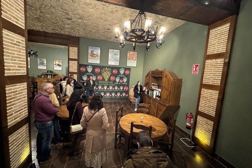 A restaurant interior with brick walls, wooden furniture, and a chandelier. 4