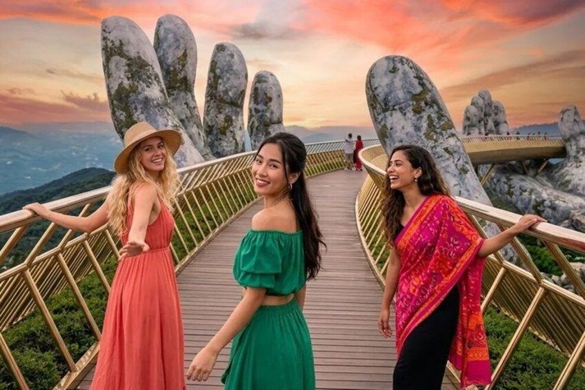 A wooden bridge with large rock formations on either side, overlooking a mountainous landscape. 1