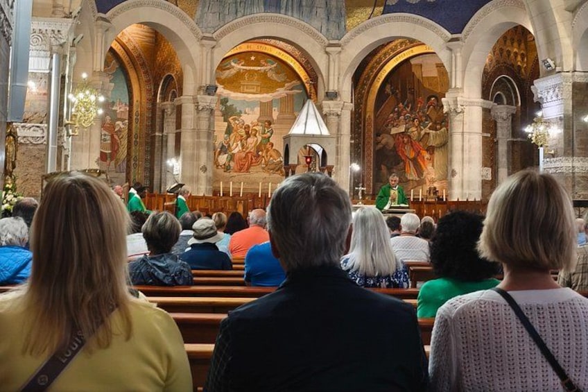 A church interior with an altar, pews, and a congregation. 4