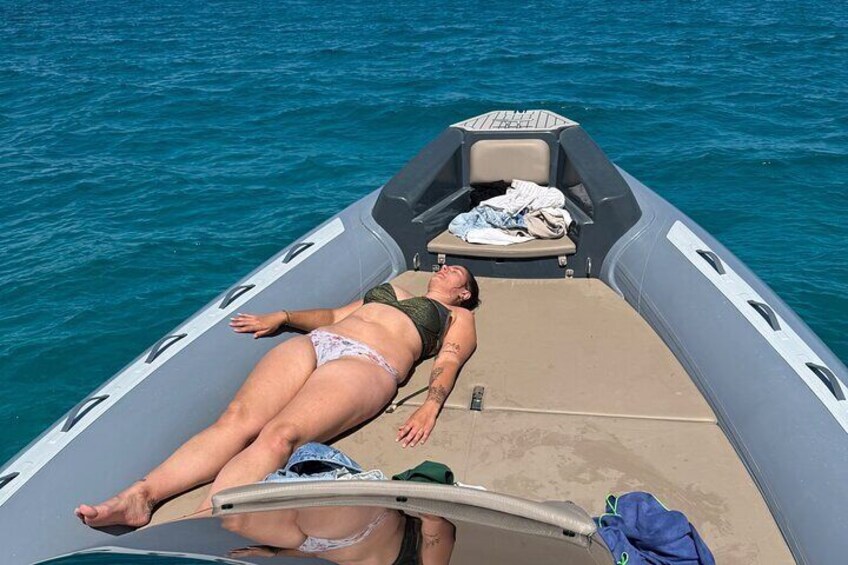 A person lying on a boat in the water. 4