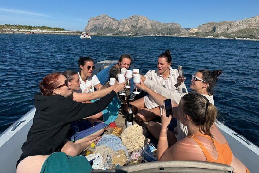 A group of people on a boat, taking photos and enjoying drinks. 5