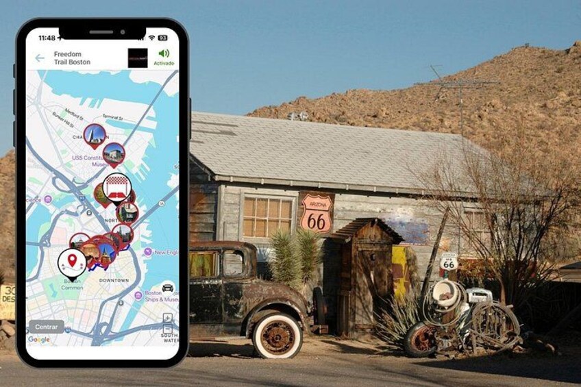 Uno smartphone mostra una mappa con diversi luoghi, un camion d'epoca e un edificio con un cartello '66'. 1