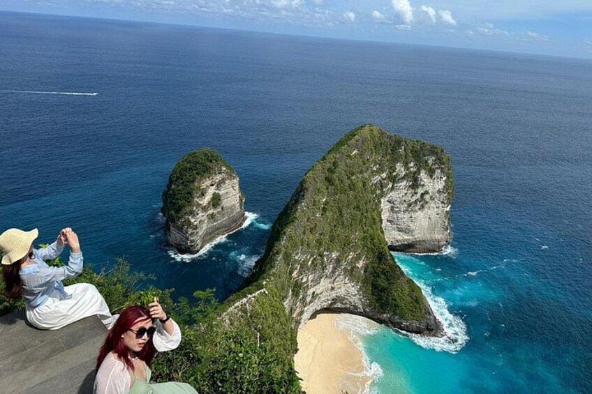 A coastal landscape with a prominent rock formation and a sandy beach. 2