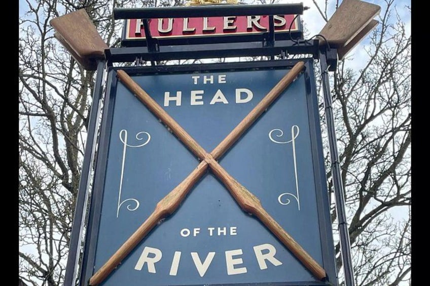 A sign with 'The Head of the River' and a wooden structure above it. 2