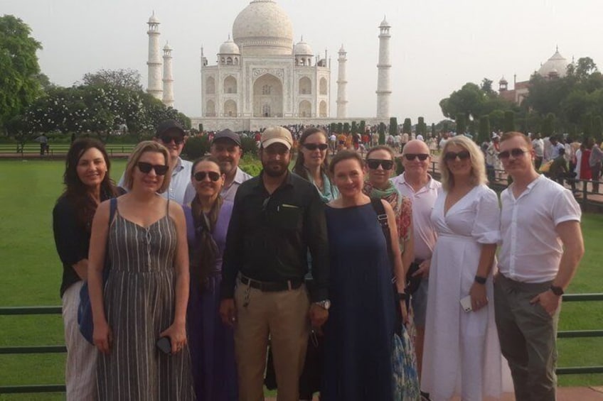 A group of people standing in front of the Taj Mahal. 3