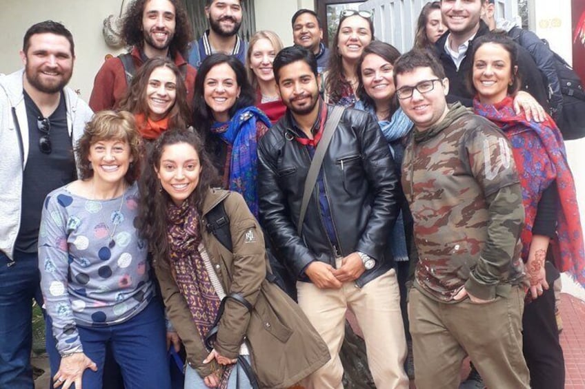 A group of people posing for a photo outdoors. 5