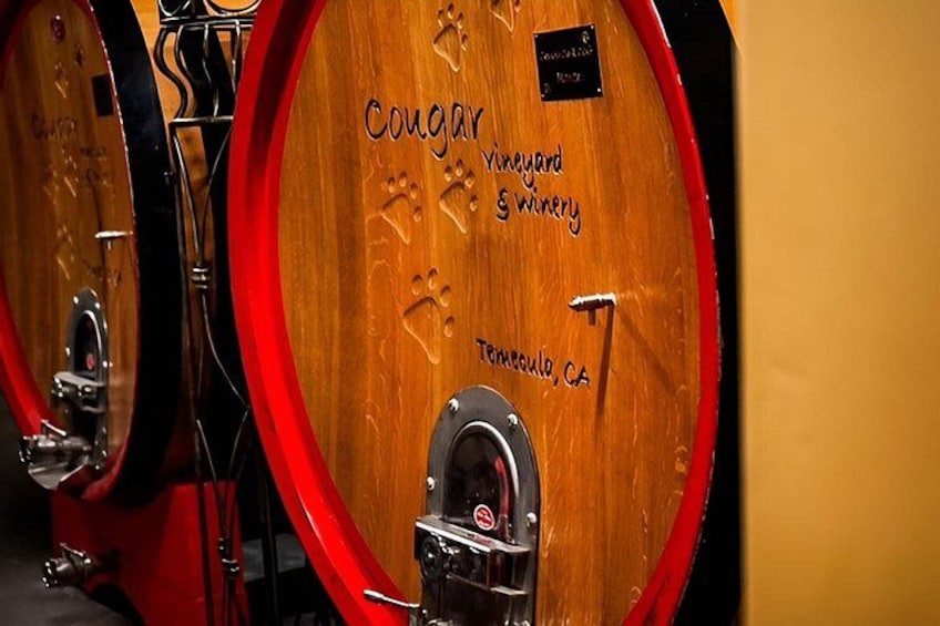 Wooden wine barrels with 'Cougar Vineyard' and 'Temecula, CA' engraved on them. 3