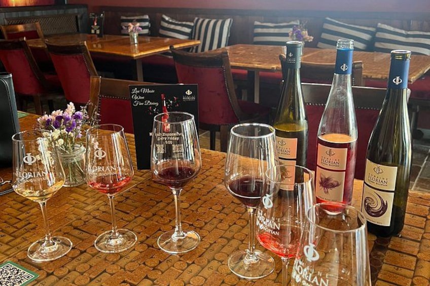 A restaurant table with wine glasses and bottles. 2