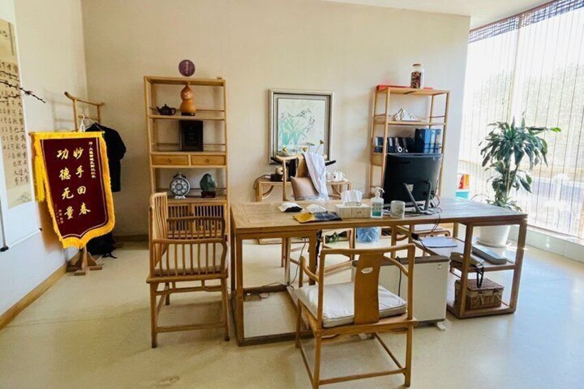 A room with a wooden table, chairs, shelves, and a plant. 4