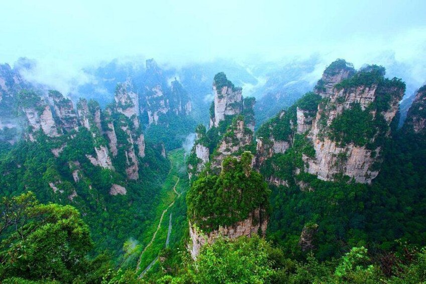 A mountainous landscape with steep cliffs and dense greenery. 3