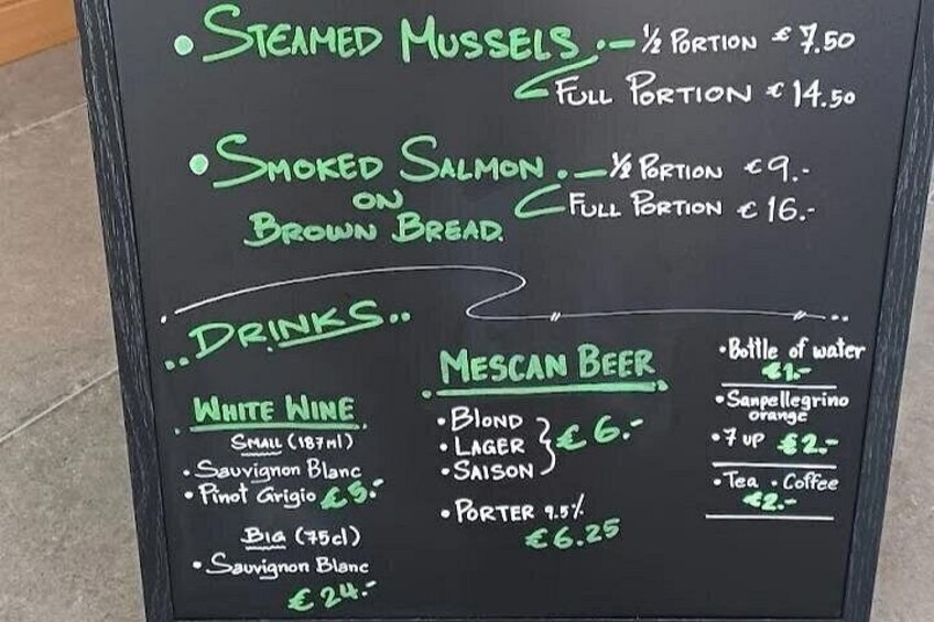 A menu with items like steamed mussels, smoked salmon, and various drinks. 4