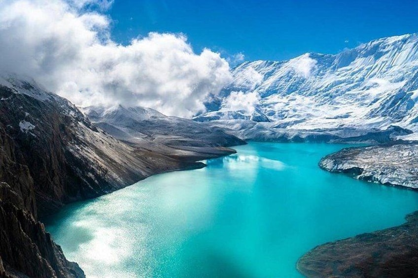 A glacier lake surrounded by snow-covered mountains. 1
