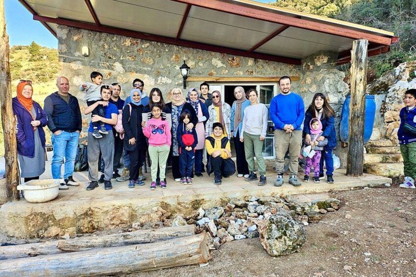 Un grupo de personas frente a un edificio de piedra con techo de metal. 2