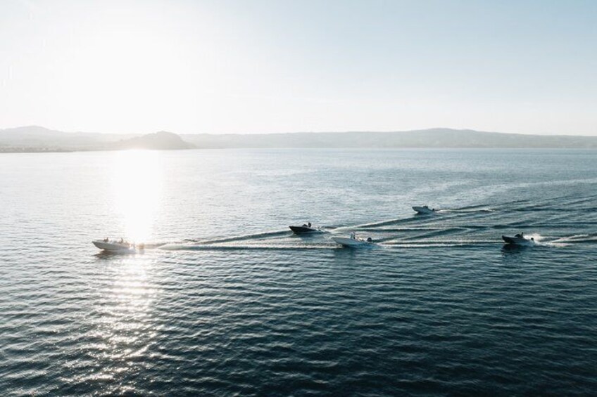 A calm sea with several boats. 2