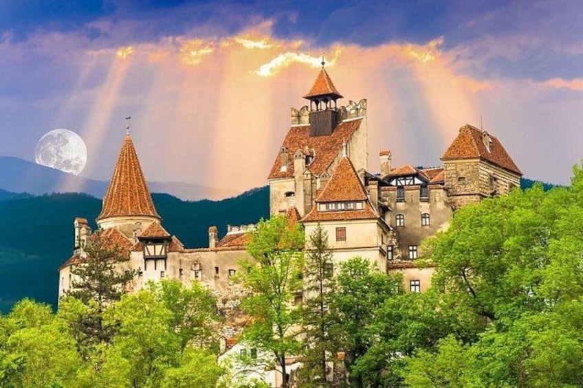 A castle with multiple towers, surrounded by lush greenery and mountains. 5