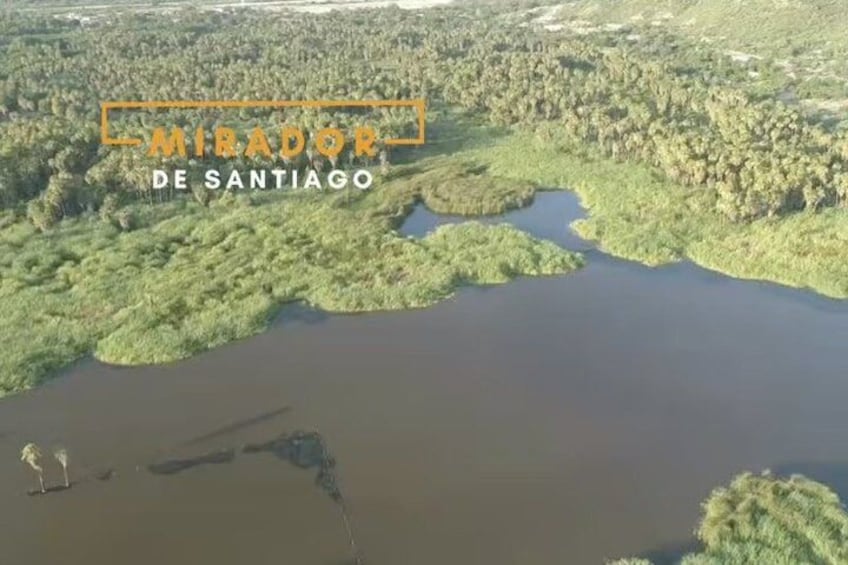 A river surrounded by dense forest, with a boat visible in the water. 4