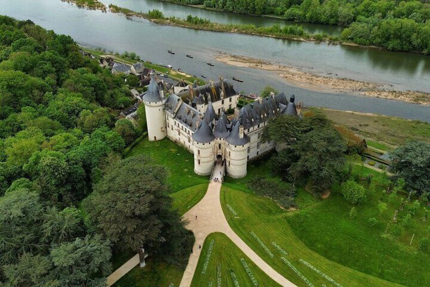 An aerial view of a castle with a river in the background. 5