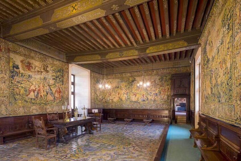 A richly decorated room with ornate ceiling, detailed wall murals, and a patterned floor. 4