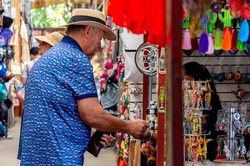 A person shopping at a market stall with various items on display. 4