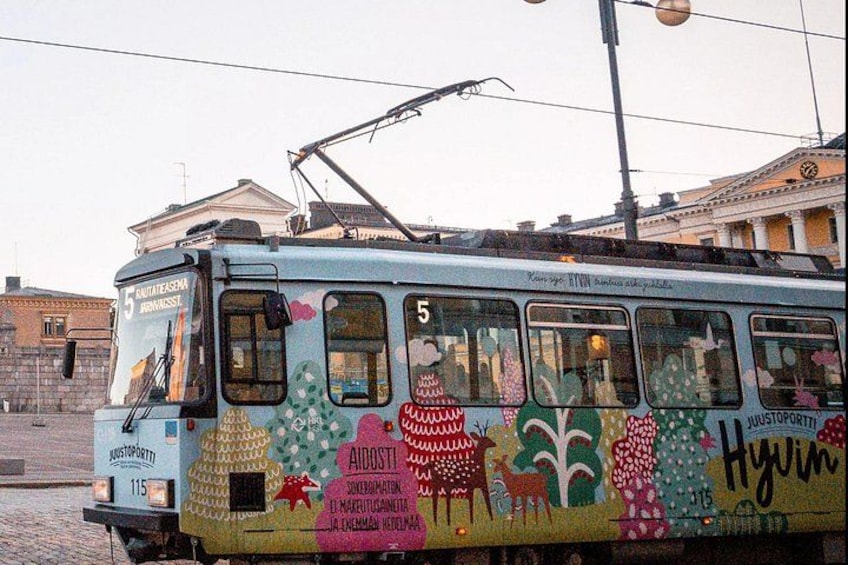 A colorful tram with artistic designs and the number 5. 3