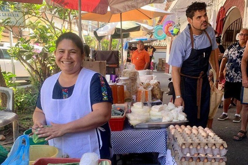 A street vendor with a stall selling eggs and other food items. 5
