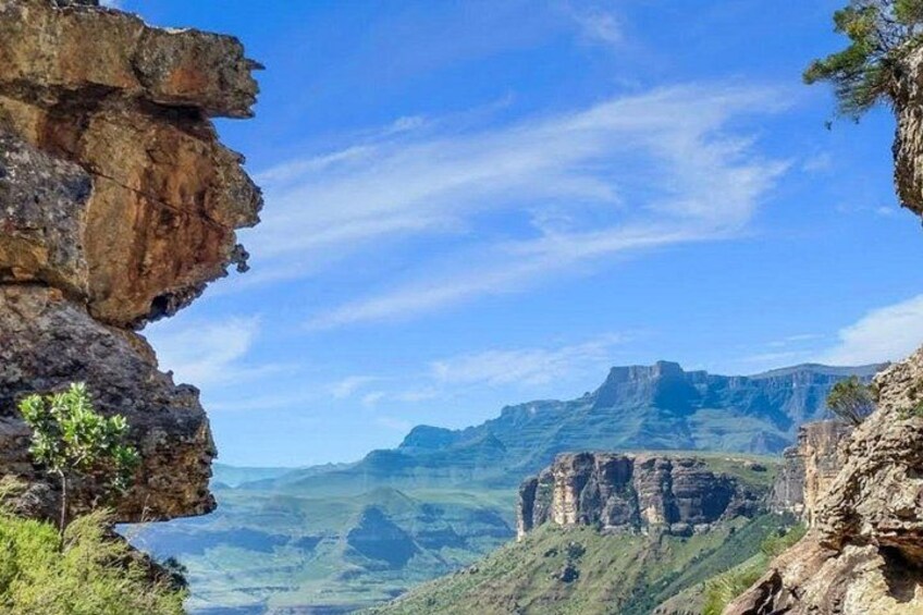 A mountainous landscape with rocky cliffs and a valley. 5