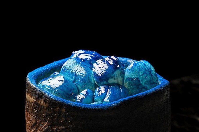 A blue crystal in a wooden container. 3