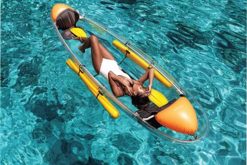 A person floating in a clear blue pool using an inflatable raft with yellow floats. 3