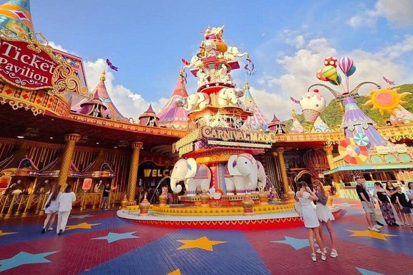 A colorful pavilion with a ticket booth, a large elephant statue, and a star-patterned floor. 1
