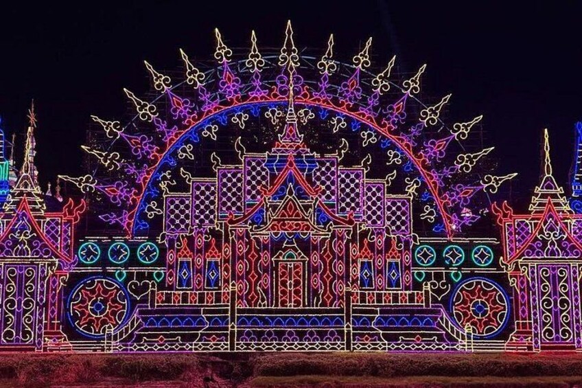 A brightly lit architectural structure with intricate patterns and designs, featuring a central archway and multiple spires. 4