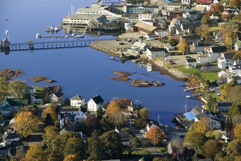 A coastal town with houses, a pier, and a body of water. 5