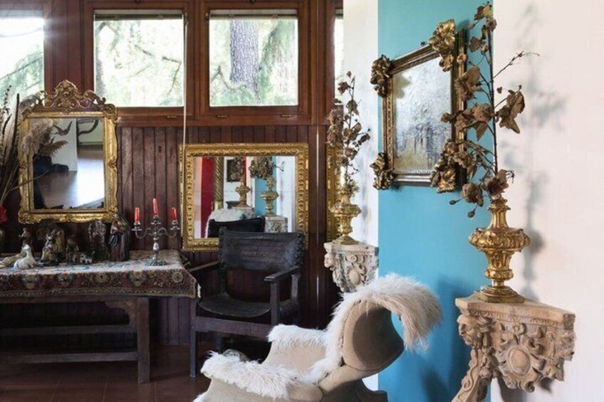 A room with antique furniture, ornate mirrors, and decorative vases. 3