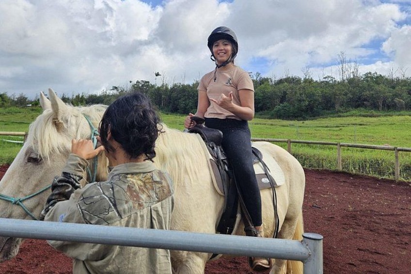 A person riding a white horse, another person in camouflage, and a rural landscape with a fence. 2