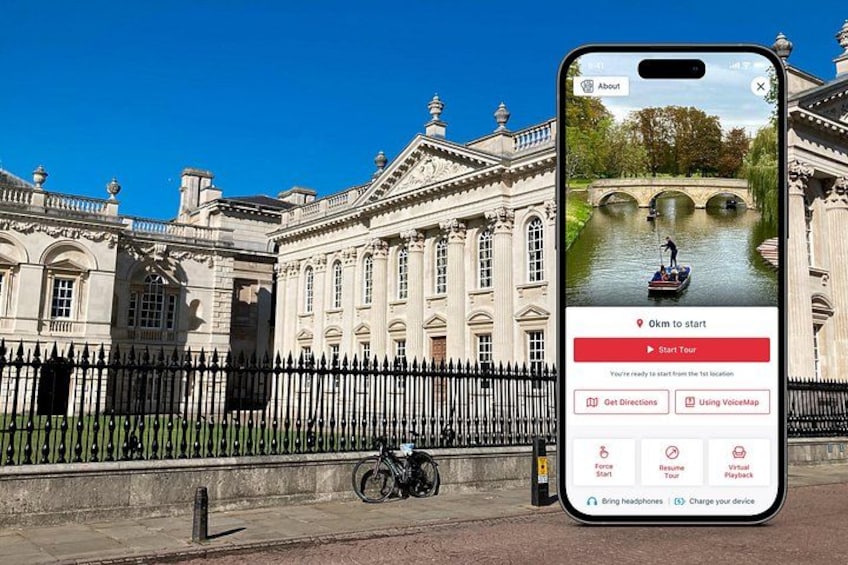 En historisk bygning med en flod foran, en cykel og en smartphone, der viser et kort. 1