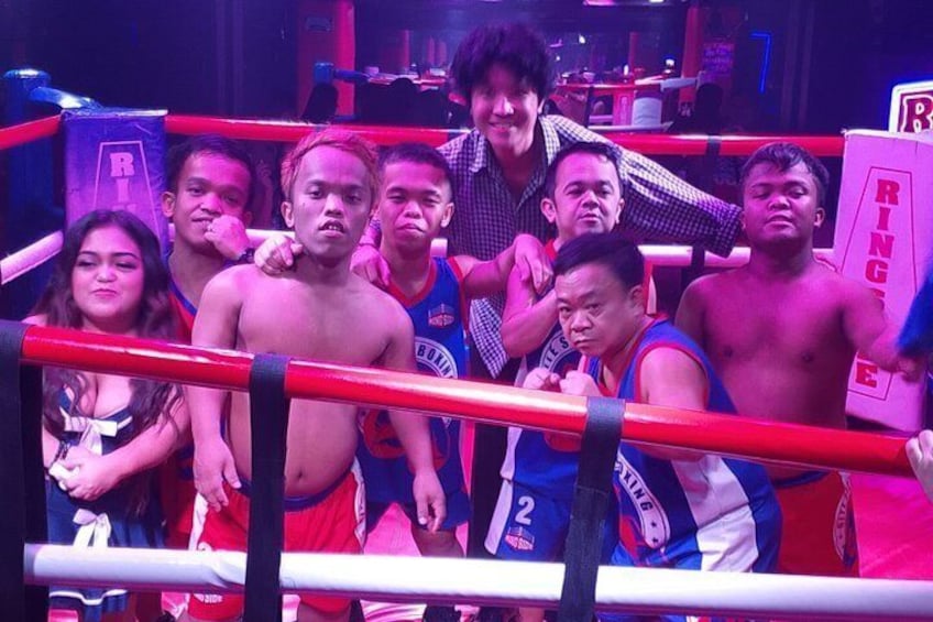 A boxing ring with people around it. 3