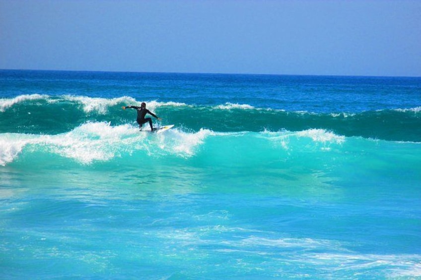 A surfer riding a wave in the ocean. 5