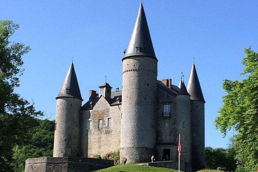 A castle with multiple towers and a flag. 3