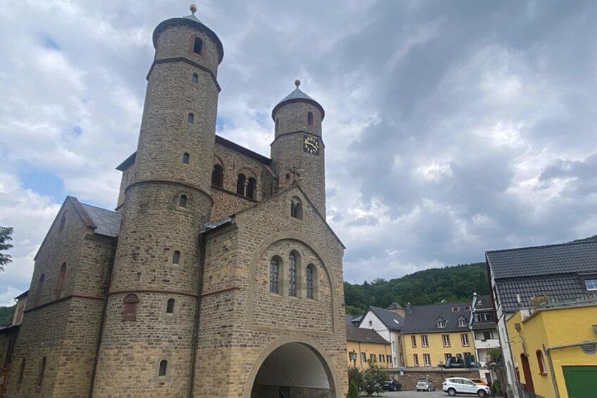A historic church with two towers and a large arched entrance. 5
