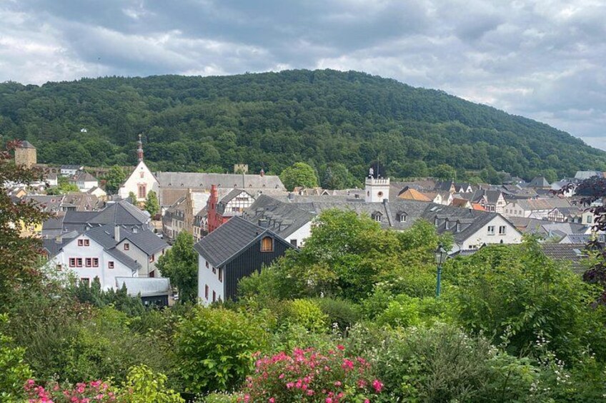 A town with historic buildings, a church, and a hill in the background. 4