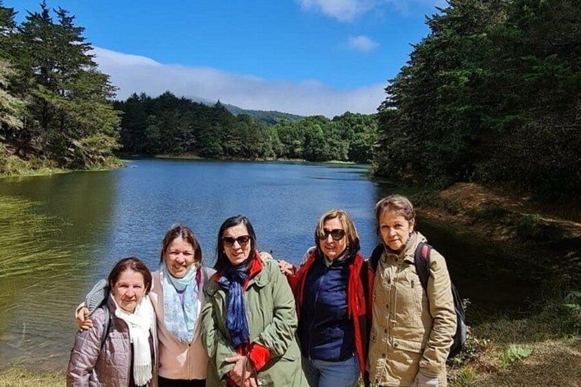 Tourists relax by the serene Don Manuel Lagoon, surrounded by pure nature and the mystical charm of the cloud forest. 4