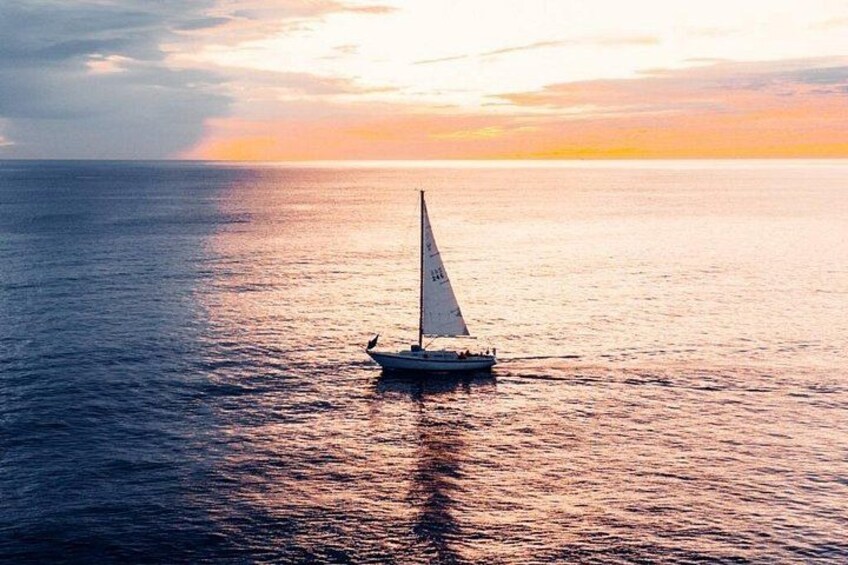 A sailboat on calm waters during sunset. 2