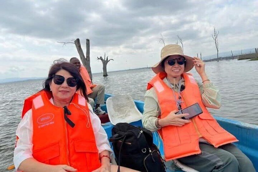 Two people in a boat wearing orange life vests. 3