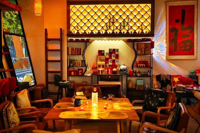 A traditional dining room with wooden furniture, a central table with a candle, and a decorative wall with a lattice design. 5