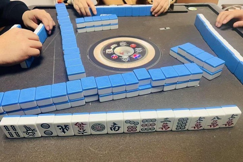 A Go board with blue and white stones, a circular center, and Chinese characters. 2