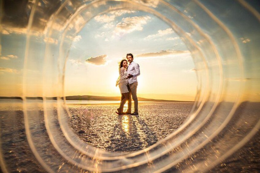 A couple embracing on a beach at sunset. 1